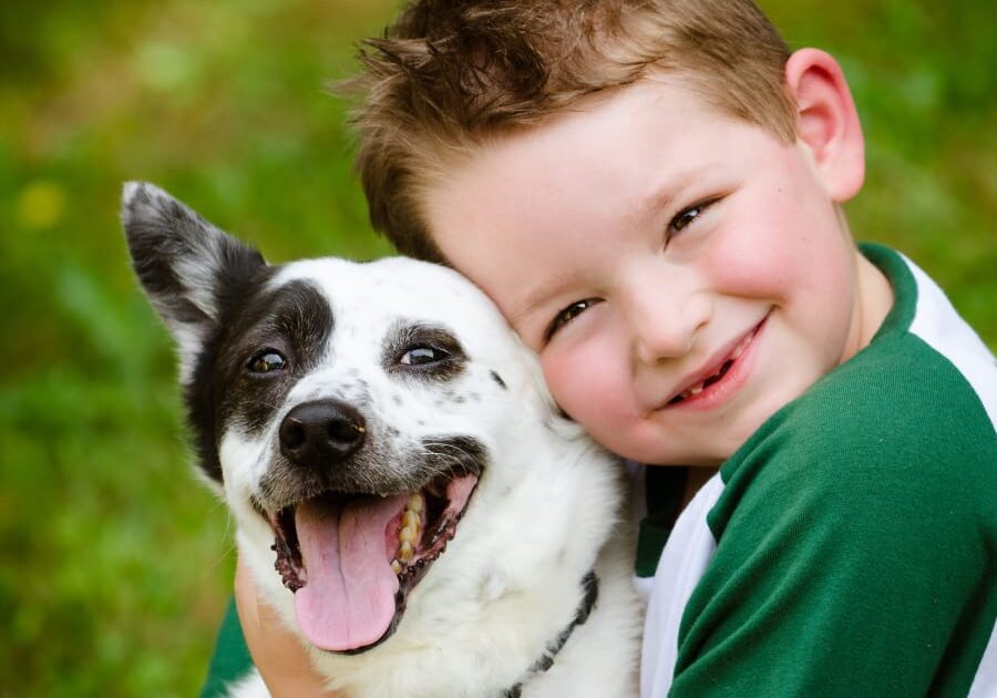boy hugging dog